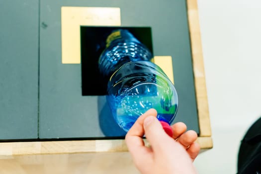 Hand of young man throwing plastic bottle in a recycling trash bin