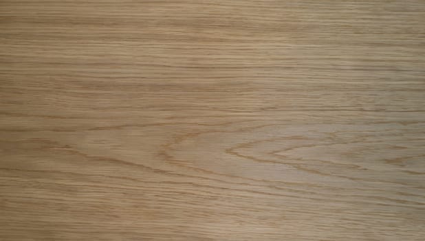 Wooden texture of laminate board or parquet closeup. Light yellow partially brown wooden texture concept