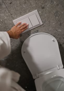 Economical toilet flush button with two separate buttons in white. Double flush toilet bowl concept