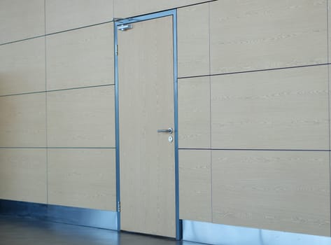 Light brown door and wall in building of airport station or business center. Stylish fashionable loft design in business centers