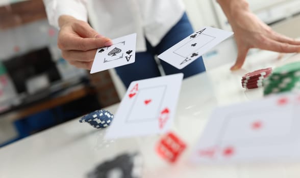 Person throws playing cards on table. Playing poker and gambling in the casino