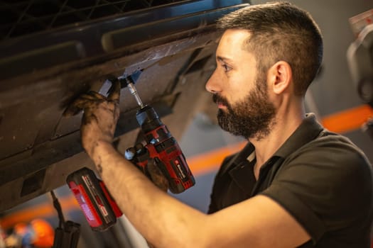 Milan, Italy 9 April 2024: Mechanic's hands delve into car engine under the hood, symbolizing repair and maintenance.