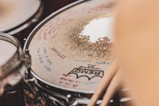 Milan, Italy 1 April 2024: A close up of a vibrant drum set covered in intricate writing, each stroke telling a musical tale with rhythms and beats.