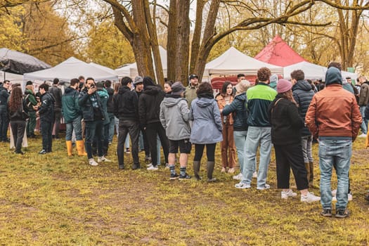 Milan, Italy 1 April 2024: A line of eager attendees waiting for entrance to a rave party, capturing the anticipation and excitement.