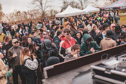 Milan, Italy 1 April 2024: Energetic young people lost in the rhythm, dancing together at a lively rave party outdoor