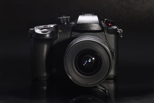 Black digital photo and video camera closeup background