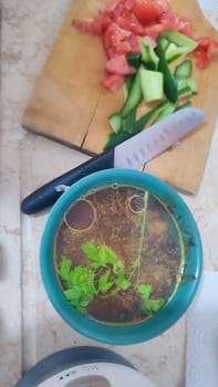 soup in a plate, tomatoes and cucumbers on a board, food lunch cooking. High quality photo