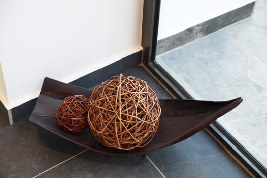 decorative wicker balls in wooden bowl home decor.
