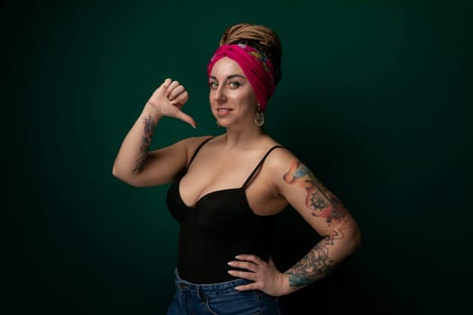 A woman wearing a pink headband is pointing directly at the camera. She appears confident and assertive in her gesture, engaging the viewer with eye contact.