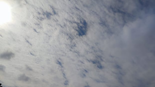 Blue gray light sky nature white clouds whether background, sun face . High quality photo