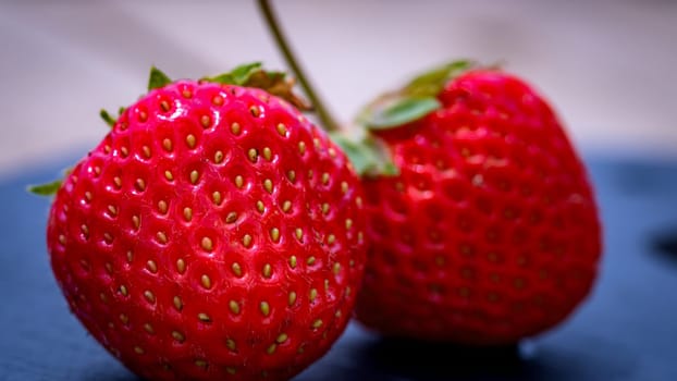 Close up of fresh strawberries showing seeds achenes. Details of fresh ripe red strawberries.