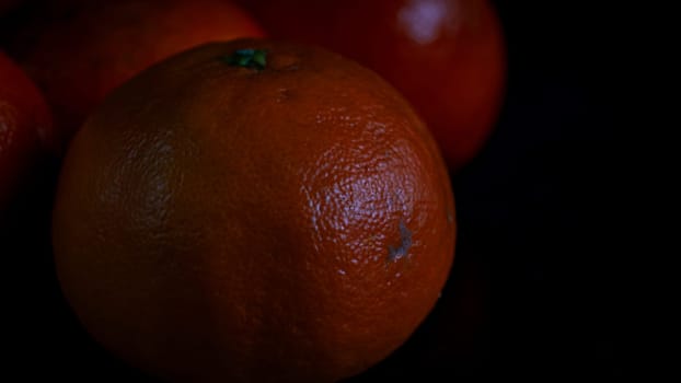 Detail of orange fruit on black background