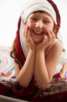 Portrait of Little girl in a stylized Tatar national costume on a white background in the studio. Photo shoot of funny young teenager who is not a professional model