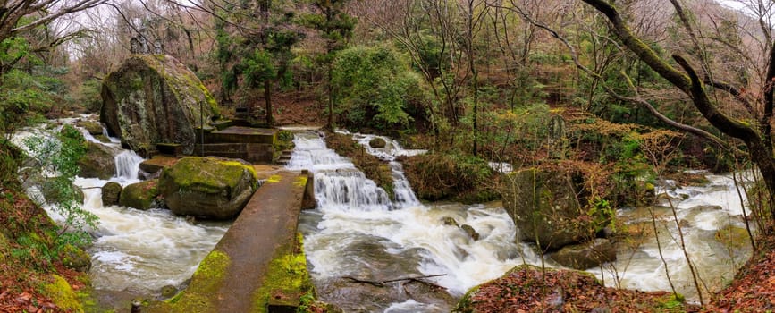 Flowing water floods stairs by bridge and Japanese in shrine after rain. High quality photo