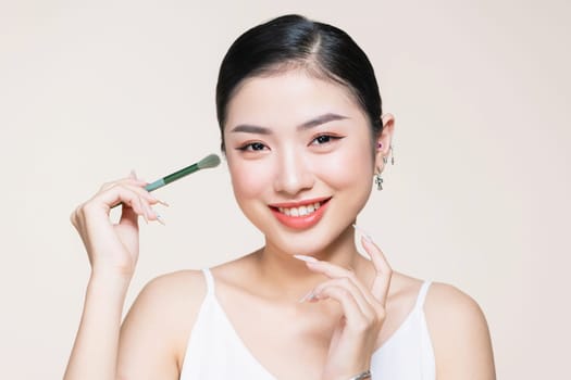 a young woman having eyeshadow added to her eyelids