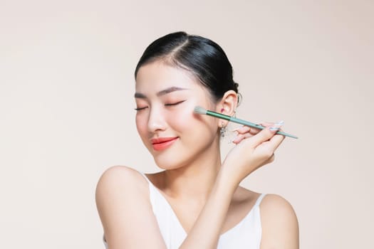 Portrait of a woman applying eyeshadows