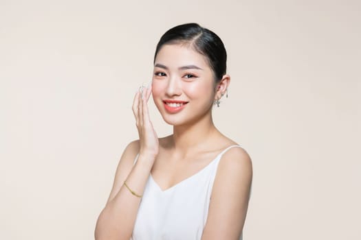 Asian woman touching her face