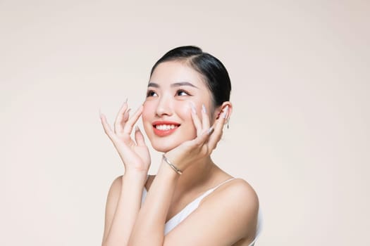 lovely girl with shiny smile touching her cheek, woman with light mua and perfect teeth
