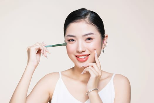 Portrait of a woman applying eyeshadows