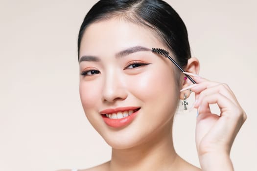 Girl makes makeup. Beautiful woman apply mascara on eyelashes with cosmetic brush