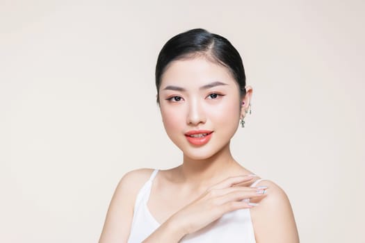 Skin protection, Young asian woman's hand is touching her smooth skin on the shoulder