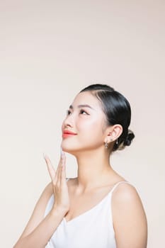 Beauty Model pointing with Finger on Perfect Chin and Neck