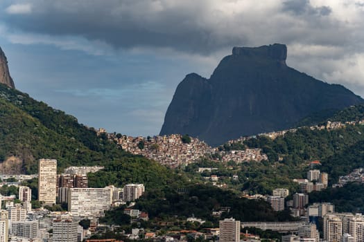 Iconic Rocinha favela lies at Two Brothers hill and Pedra da Gavea base in Rio de Janeiro.