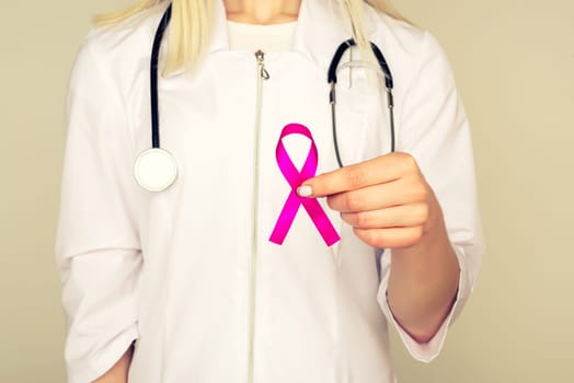 Female Doctor Holds Pink Ribbon, International Breast Cancer Day October 7 - Image