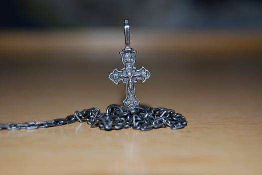 Jewellery decoration. Chain with a cross.Cross with crucifix and dark chain.