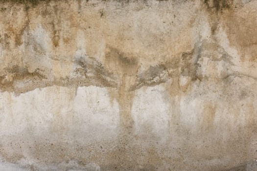 Old water damaged grey plaster wall surface with yellow smudges. Full-frame flat background and texture.