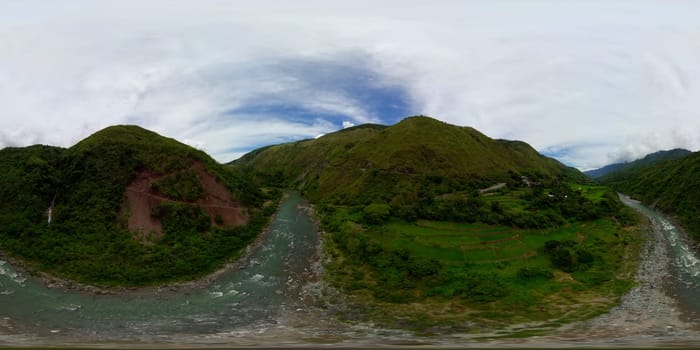 Waterfall and river among in the mountains. Rice terraces on the slopes of the mountains. 360VR. Philippines, Luzon.