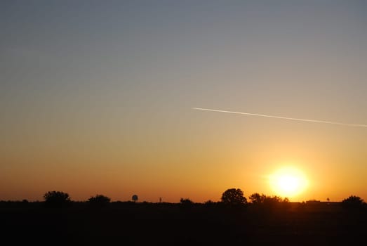 Sky, sun, evening and air plane with contrail.