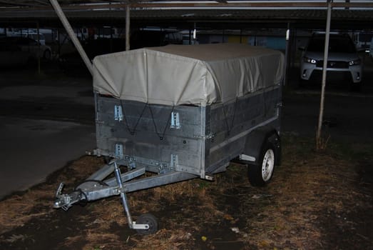 Tall curtain trailer, two-axle, gray.