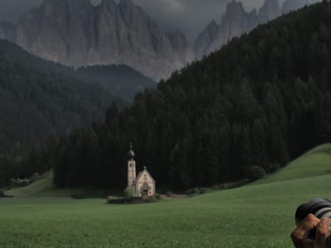 photographer taking picture of ranui church in south tyrol funes valley dolomites italy view