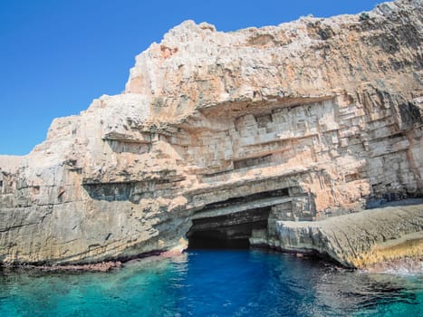 vis island croatia turquoise water and rock cliff, transparent clear sea water during a bright summer day