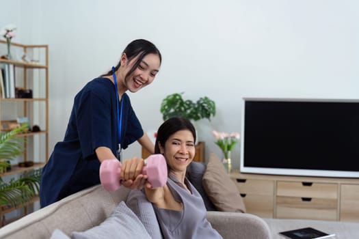 Asian female doctor advice elderly patient to physiotherapist to exercise at home.