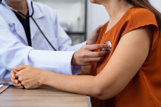 Doctor listens to heartbeat of older of retirement age to check their heart rate.