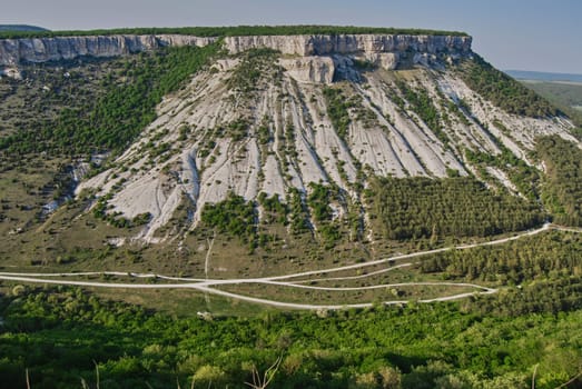 The rock has an unusual appearance, similar to an earthen embankment washed away by heavy rains.