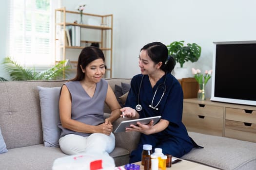 Doctor or nurse caregiver showing a prescrption or documents and holding drug bottle to senior man at home or nursing home.