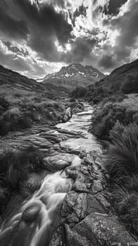 A black and white photo of a stream running through the mountains