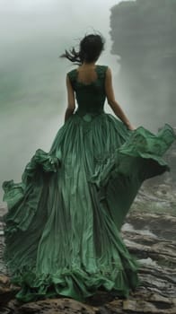 A woman in a green dress walking on rocks near water