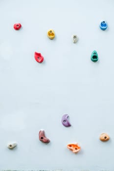 Colorful climbing holds on wall for outdoor rock climbing