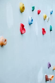 Colorful climbing holds on wall for outdoor rock climbing