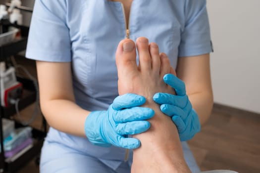 Close up a man undergoes a foot massage session by a professional masseur at the clinic