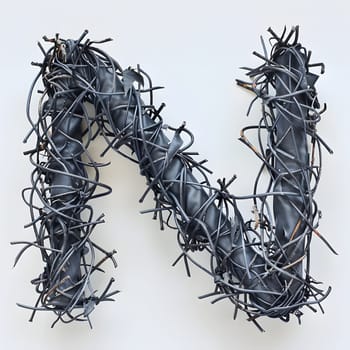 The letter n is creatively constructed using barbed wire, resembling a plant twig with thorns and spines. This unique font in electric blue color is a stunning example of environmental art