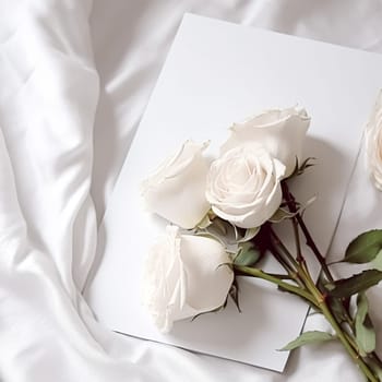 Floral composition. White flowers on white fabric. Flat lay, top view, copy space.