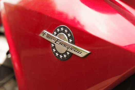 Cambrai, France - May 21, 2023: A detailed view of the emblem on a red Pan European motorcycle, highlighting the brands logo and metallic finish.