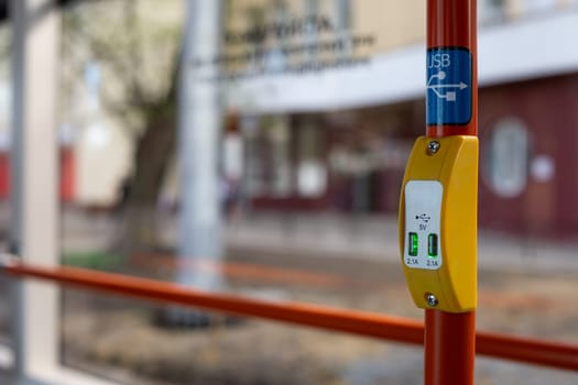 Handrail of modern public transport with USB connector for charging your phone while traveling on city transport