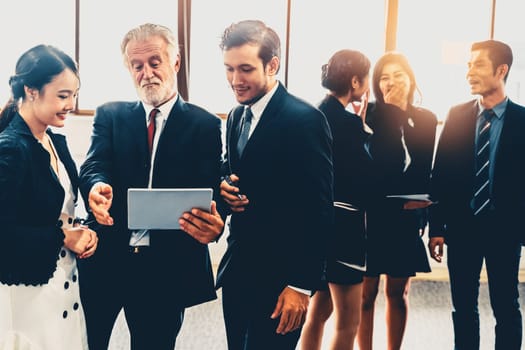 Many young businessmen and businesswomen in group meeting standing at conference hall in office. Multicultural company organization unity and support. Concept of partnership and human resources. uds