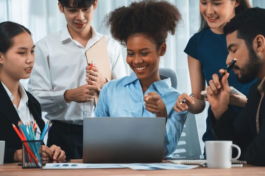 Happy diverse business people work together, discussing in corporate office. Professional and diversity teamwork discuss business plan on desk with laptop. Modern multicultural office worker. Concord